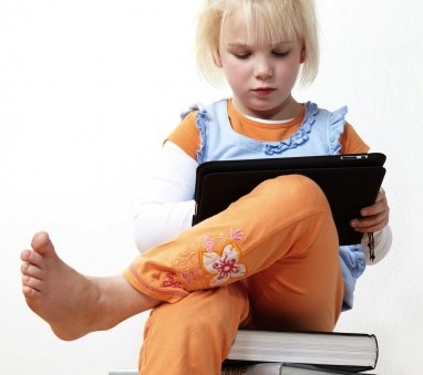 little girl using an ipad