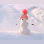A photograph of 2 snowmen wearing knitted hats.