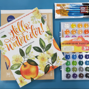 Hello Watercolor! book, watercolor paint set and brushes all on a blue background